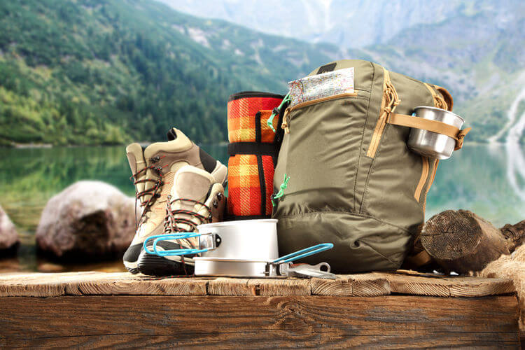 Camping equipment sitting on the wall against mountain background