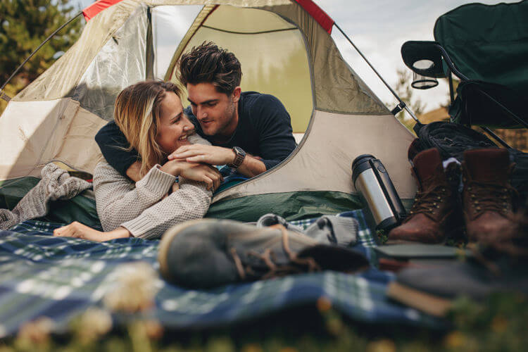 Young couple camping in a tent
