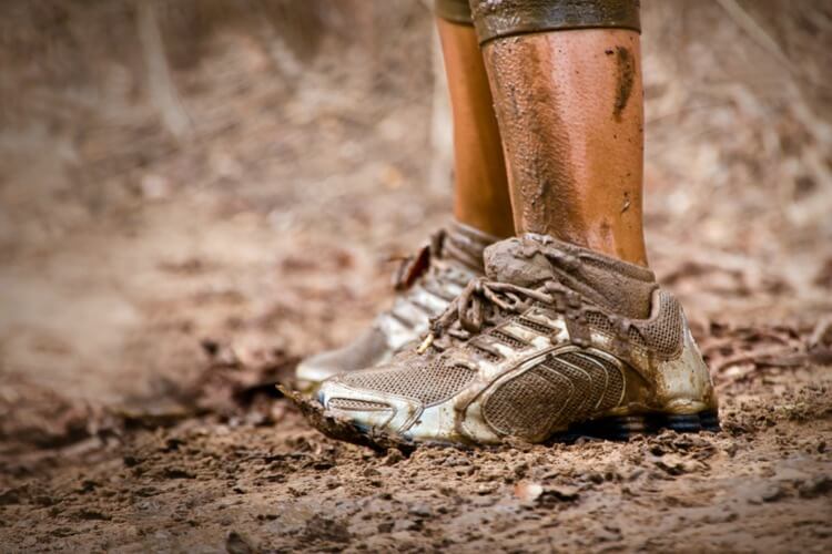 Endurance runners feet in mud