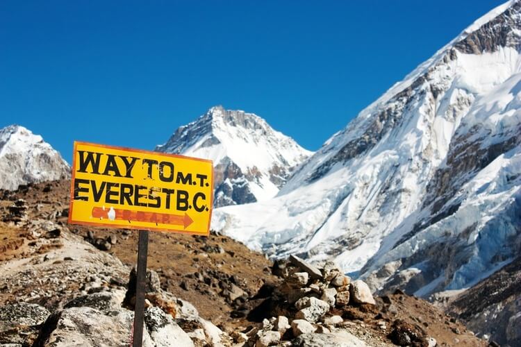 View of Mount Everest from below with sign