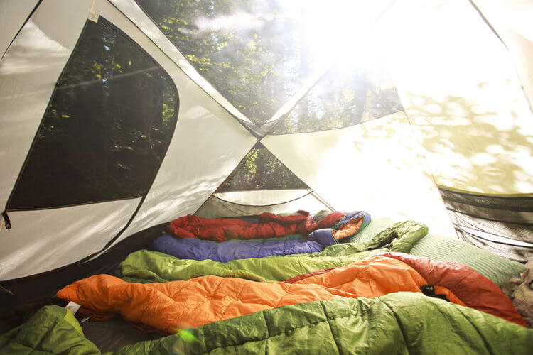 Row of sleeping bags in tents