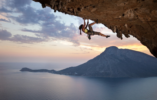 Woman rock climbing on an overhang