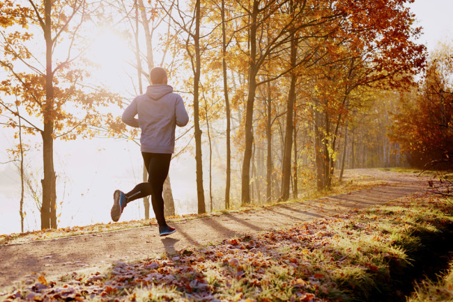 Man running in a forest in autumn