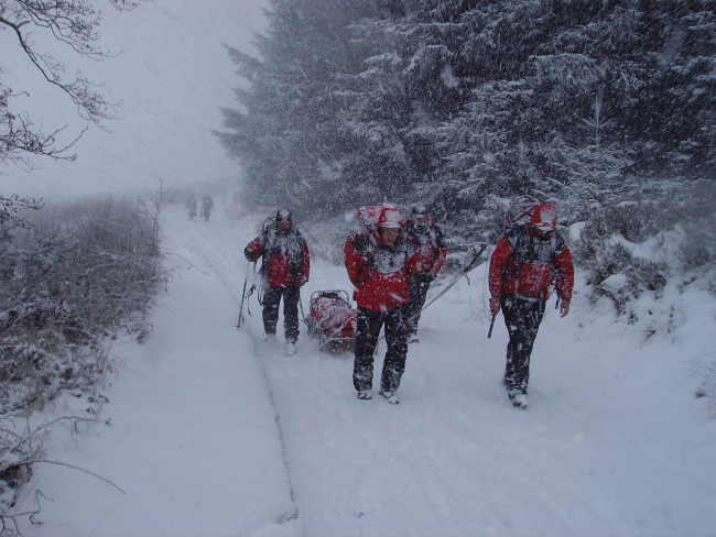 Mountain rescue rescuing someone in the snow
